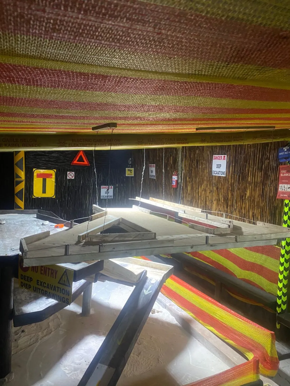 Upper track level with suspended walkways and deep excavation signs
